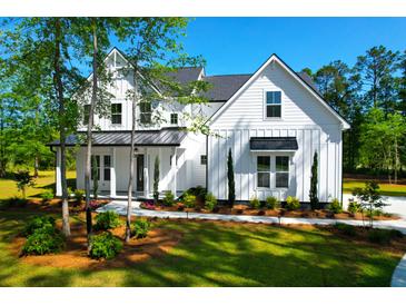 Stunning two-story home with a modern farmhouse design and a beautifully landscaped front yard at 202 Countryside Way, Summerville, SC 29483
