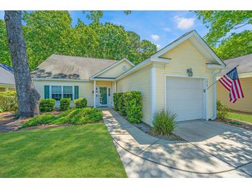 Charming yellow home with a lush front yard and inviting curb appeal at 2418 Tuscany Dr, North Charleston, SC 29406