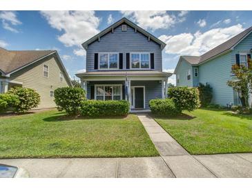 Charming two-story home with a well-manicured lawn and inviting front porch in a suburban neighborhood at 317 Pimpernel St, Summerville, SC 29483