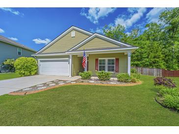 Charming single-story home featuring a well-maintained lawn and a welcoming two-car garage at 409 Carousel Ct, Summerville, SC 29483