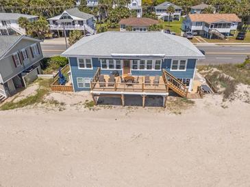 Beachfront home with a spacious deck overlooking the ocean and direct access to the sandy beach at 412 Palmetto Blvd, Edisto Island, SC 29438