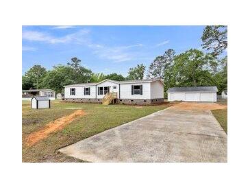 Charming home with a long driveway and detached two-car garage at 119 Silver King Ave, Cross, SC 29436