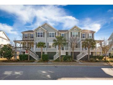 Charming townhome with double porches, palm trees and coastal architecture under a sunny sky at 1624 Prince Edward St, Mount Pleasant, SC 29466