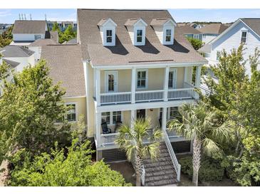 Charming two-story home featuring a spacious double porch and well-maintained landscaping at 1658 Pierce St, Charleston, SC 29492