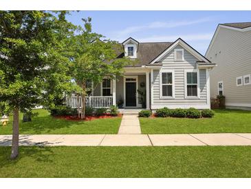 Charming gray home featuring a quaint front porch and a well-manicured lawn at 1722 Winfield Way, Charleston, SC 29414