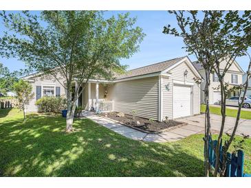 Charming single-story home with a well-maintained lawn, front porch, and attached garage at 203 Eagle Ridge Rd, Summerville, SC 29485