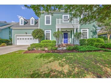 Charming two-story home with a well-manicured lawn and inviting front porch with blue door at 219 Silverwood Ln, Summerville, SC 29485