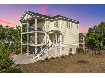 Two-story home with covered porches and stairs leading to the entrance at 2501 Myrtle St, Edisto Beach, SC 29438