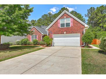 Charming two-story brick home featuring a two-car garage and well-manicured front lawn at 405 Decatur Dr, Summerville, SC 29486