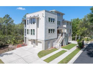 Stunning three-story home with a spacious driveway, two-car garage, and covered front porch at 4637 Bonnie Marie Way, North Charleston, SC 29405