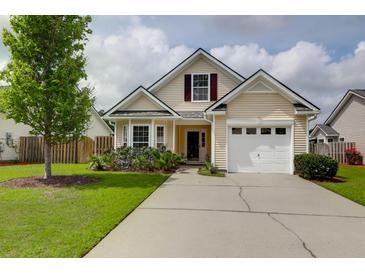 Charming two-story home with a well-maintained lawn and a white garage door at 4856 Carnoustie Ct, Summerville, SC 29485