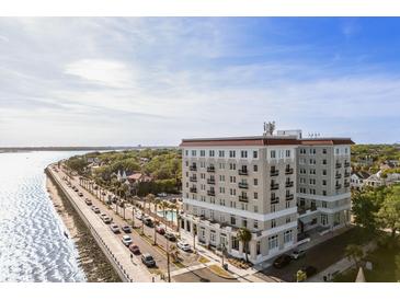 Stunning aerial view of a beautiful waterfront property with palm trees and a pool in a desirable coastal location at 1 King St # 501, Charleston, SC 29401