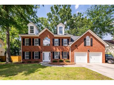 Two story brick home with black shutters, white trim, and two car garage at 107 Spalding Cir, Goose Creek, SC 29445
