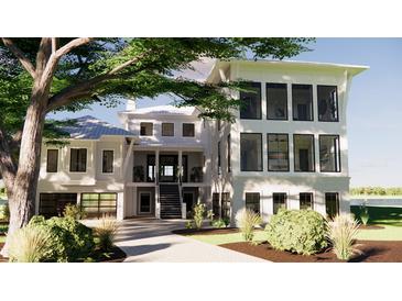 Beautiful three-story home showcasing a modern design with a charming driveway and lush landscaping at 11 Tabby Ln, Isle of Palms, SC 29451