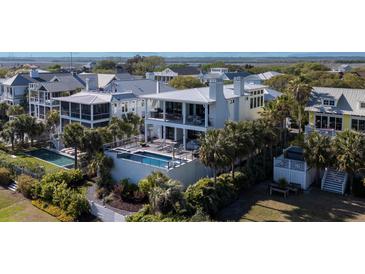 Stunning two-story home with a private pool, patio, and lush landscaping at 124 Charleston Blvd, Isle of Palms, SC 29451