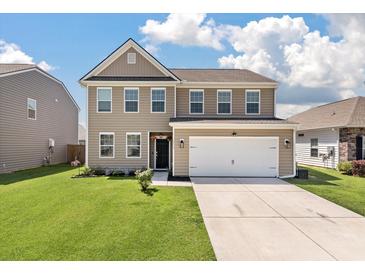 Charming two-story home features a two-car garage, neutral siding, and well-maintained lawn at 1311 Berry Grove Dr, Summerville, SC 29485