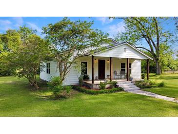 Charming single-story home with a covered front porch and well-manicured lawn at 224 Reeves St, Reevesville, SC 29471