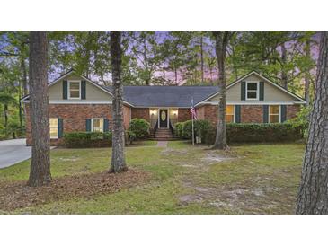 Charming brick home featuring a well-manicured lawn and symmetrical design, exuding curb appeal and classic charm at 418 Lakeview Dr, Summerville, SC 29485