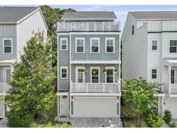 Charming three-story home featuring a rooftop deck, a two-car garage, and inviting curb appeal at 539 Cooper Village Ln, Mount Pleasant, SC 29464