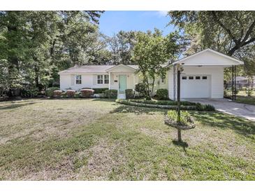 Lovely home with well-maintained lawn, mature trees, and detached garage at 710 W Harrison Rd, Charleston, SC 29407