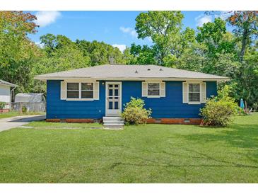 Charming single-story home with a blue exterior, well-manicured lawn, and inviting entrance at 1222 Maxwell St, North Charleston, SC 29405