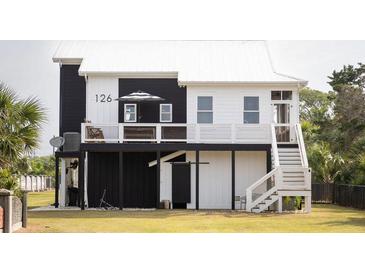 Charming elevated home with a crisp black and white exterior and a relaxing outdoor deck at 126-C Jungle Rd, Edisto Beach, SC 29438