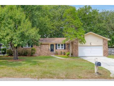 Charming single-story brick home featuring mature trees, green lawn, and nice curb appeal at 1383 W Lenevar Dr, Charleston, SC 29407