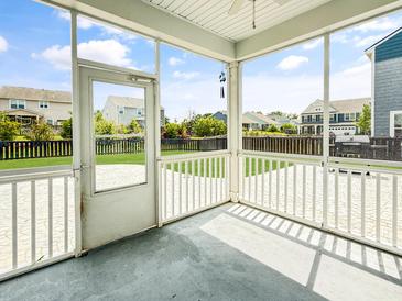 Relaxing screened patio with stamped concrete flooring and neighborhood views at 204 Lynx Ln, Summerville, SC 29483