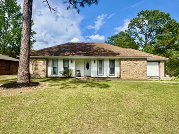 Charming single-story home featuring a brick facade, white trim, and a well-maintained lawn at 207 Longstreet St, Summerville, SC 29486