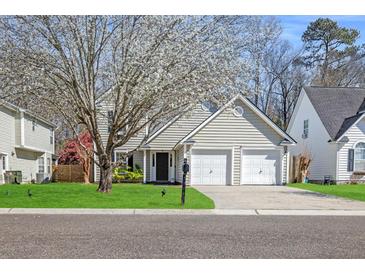 Charming two-story home with a well-manicured lawn, mature tree and a two-car garage at 350 Arlington Dr, Charleston, SC 29414