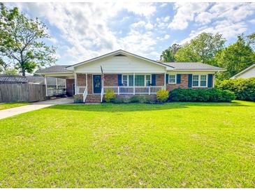 Charming single-story brick home featuring a well-maintained lawn and inviting front porch at 404 Rose Ln, Summerville, SC 29485