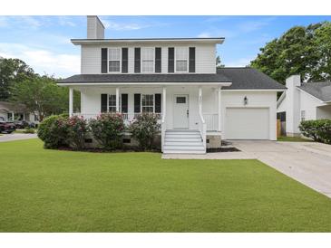 Charming two-story home featuring white siding, black shutters, a well-manicured lawn, and an attached garage at 4301 Trevor St, North Charleston, SC 29420