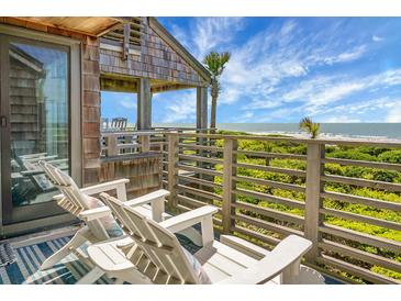 Relax on the deck with ocean views and comfortable seating, perfect for enjoying the coastal breeze at 4319 Sea Forest Dr, Kiawah Island, SC 29455
