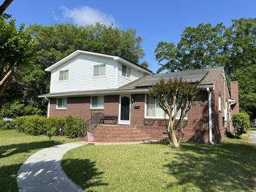 Charming two-story brick home featuring white siding, a landscaped yard, and a welcoming front entrance at 912 Kincade Dr Dr, Mount Pleasant, SC 29464