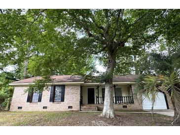 Charming brick ranch home with a cozy front porch and mature shade trees at 106 Pelican St, Ladson, SC 29456
