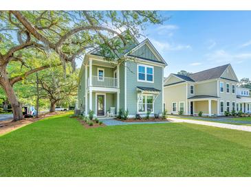 Charming two-story home featuring a covered porch, balcony, and landscaped front yard at 109 Gray Pine Ln, Summerville, SC 29483