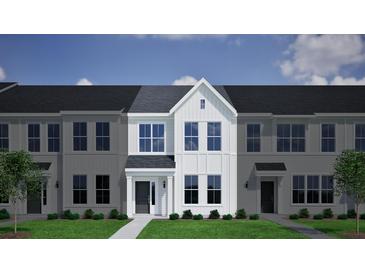 Charming townhome with light gray siding, black door, and manicured lawn creates a welcoming curb appeal at 133 Brown Swiss Cir, Summerville, SC 29483