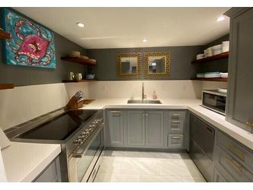 Well-lit kitchen with gray cabinetry, modern appliances and a stainless steel range at 14 Lockwood Dr # 6I, Charleston, SC 29401