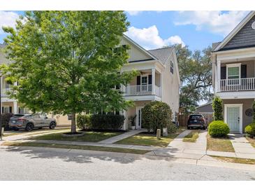Charming two-story home featuring a covered porch, well-maintained landscaping, and ample parking on a sunny day at 1817 Towne St, Johns Island, SC 29455