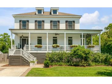 Inviting two-story home featuring a charming front porch and well-manicured lawn at 2 Piedmont Ave # A, Charleston, SC 29403