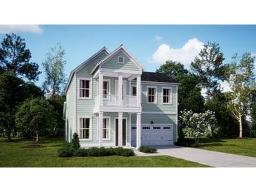 Charming two-story home with a light-green exterior, white trim, and well-manicured front lawn at 216 Yalton St, Summerville, SC 29486
