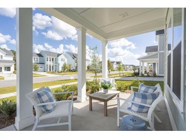 Inviting front porch with seating, perfect for relaxing and enjoying the neighborhood view at 220 Callibluff Dr, Summerville, SC 29486