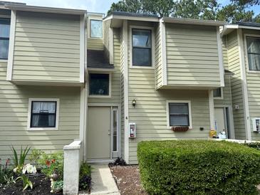 Inviting townhouse with unique architecture, light green siding, and well-maintained landscaping at 2314 Treescape Dr # 2406, Charleston, SC 29414