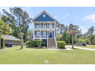 Charming blue two-story home with double front porches and manicured landscaping at 2919 Zachary George Ln, Johns Island, SC 29455