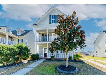 Charming two-story home with double porches and a landscaped front yard at 309 Peters Creek Dr, Summerville, SC 29486