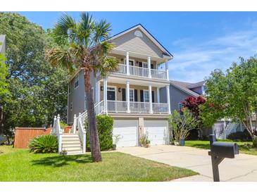 Charming two-story home featuring double balconies, a well-manicured lawn and a lovely palm tree at 352 Clayton Dr, Charleston, SC 29414