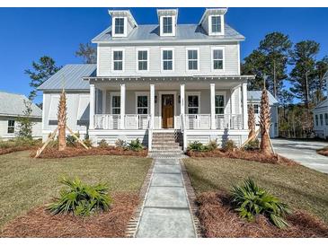 Charming two-story home showcasing a welcoming front porch and manicured lawn on a sunny day at 3894 Summerton St, Mount Pleasant, SC 29466