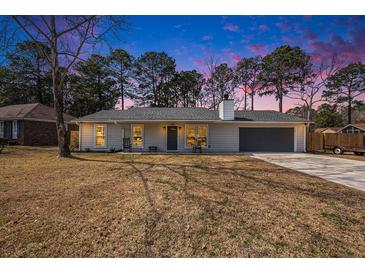 Charming home with a gray front door, inviting porch, and a well-maintained lawn at 402 Woodward Blvd, Summerville, SC 29483
