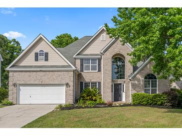 Charming two-story brick home with a well-manicured lawn and attached two-car garage at 5413 Barnsley Dr, North Charleston, SC 29420
