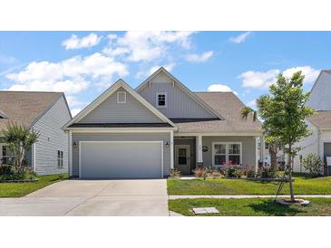 Charming home with a manicured lawn, two car garage and beautiful curb appeal at 629 Snow Owl Dr, Summerville, SC 29486